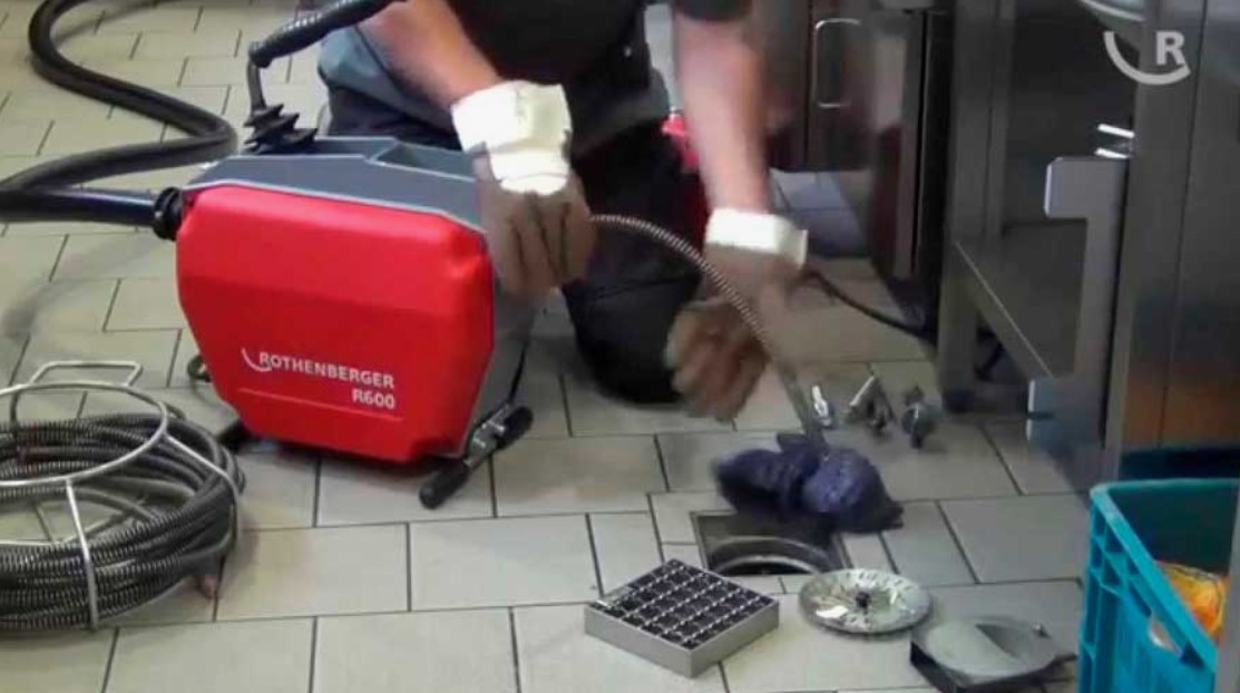 Técnico desentupidor desentupindo ralo interno